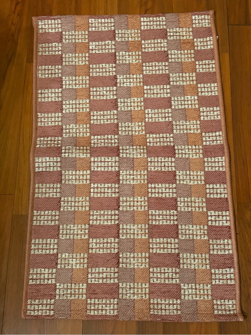 Woven Checkerboard Accent Rug in Rose and Cream